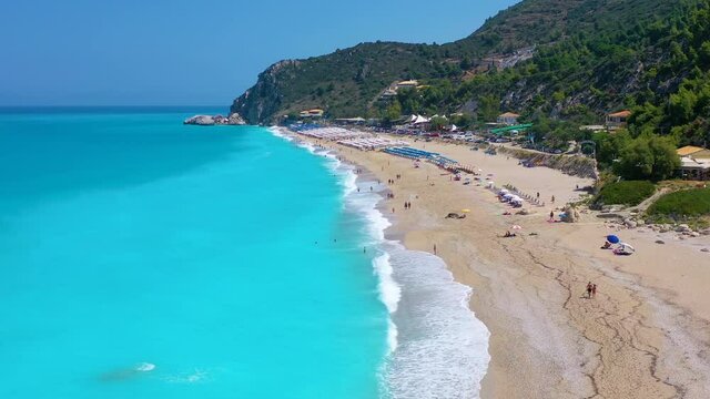 The popular Kathisma Beach on the Greek island of Lefkada with blue sea and rows of umbrellas, Greece
