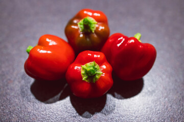 freshly picked mini red bell pepper capsicums on kitchen benchtop, c, simple ingredients concept
