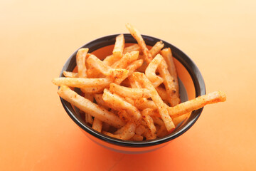 Bowl with tasty potato chips on wooden background .