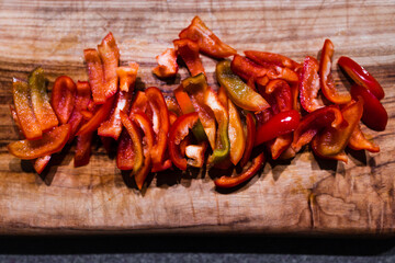freshly picked mini red bell pepper capsicums chopped up on cutting board, simple ingredients...