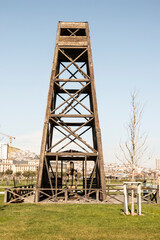 Fototapeta premium The method of oil production in the early 20th century. Wooden drilling rig. Flammable production.