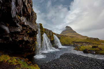 Kirkjufellsfoss waterfall with Kirkjufell cliff in the background in Iceland