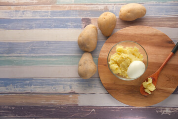 top view of slice of raw potato and egg in a bowl 