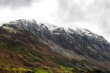  dramatic  photo of the wintry autumn weather and snow capped mountains in the Nant Ffrancon Pass and Ogwen valley in Snowdonia National Park in North Wales.