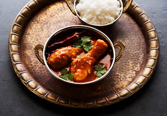 Spicy chicken legs with rice. Indian dish Spicy Chicken Curry. Top view