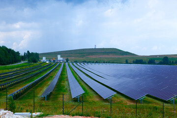 Farm with solar electric panels on a green field