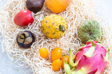 Fototapeta na wymiar exotic fruits on hay background