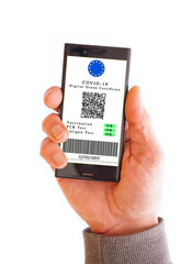 Cell phone with Green Digital Cetrificate. Vaccinated person with digital health passport app in mobile phone for travel during covid-19 pandemic