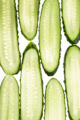 Cucumber green slices pattern isolated on white background. Creative cucumbers wallpaper, food backdrop design