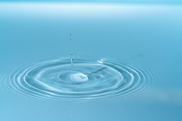 Waves on the surface of the water from a collision. Drop of water drop to the surface.