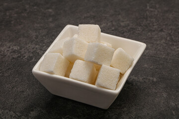 Refined white sugar cubs in the bowl