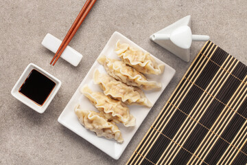 Gyoza, Dim Sum or dumplings snack is Japanese food and Chinese food, with  white plate ceramic and...
