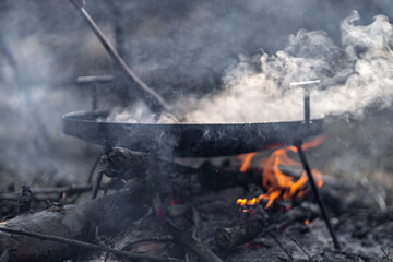 cooking in the forest nature campfire with smoke and sun