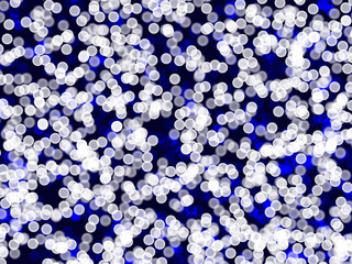 White and blue bokeh. Xmas glitter particles. Abstract night background.