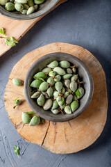 Fresh unripe almonds on wooden background. Top view.