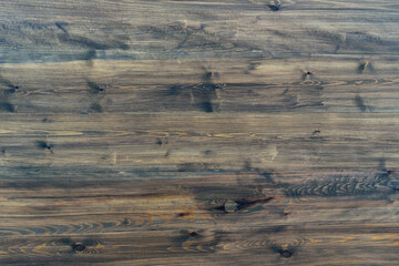 Wooden surface for the backdrop. Blackened horizontal boards.