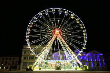 Colourful ferris wheel at night in France