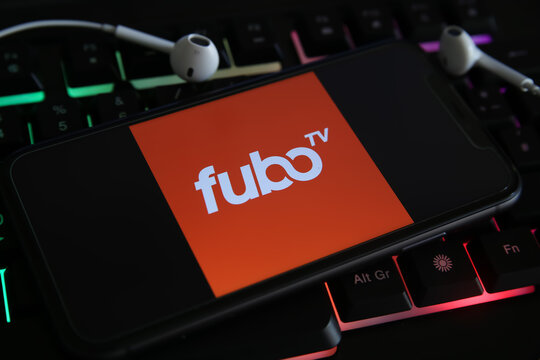 Viersen, Germany - March 1. 2021: Closeup of mobile phone screen with logo lettering of streaming service fubo tv on laptop keyboard