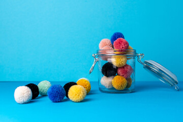 mason jar with hand made yarn pompoms for crafts 