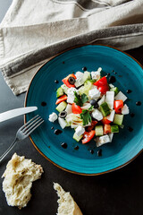 Delicious healthy dietary fresh salad with fresh vegetables, herbs, olive oil. Healthy Diet Snack. Beautiful still life, photo for the restaurant menu	
