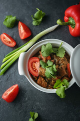 
Delicious lunch, Meat stew with fresh tomatoes in tomato sauce. A hearty dinner. Beautiful still life, photo for the restaurant menu