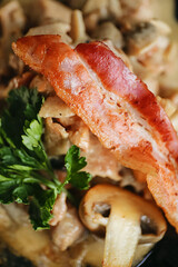 Delicious lunch, hot dish with mushrooms, potatoes and fried bacon. A hearty dinner. Beautiful still life, photo for the restaurant menu