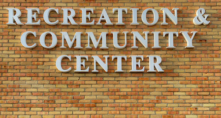 Recreation and community center sign on yellow brick building