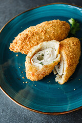 Cutlet in batter of chicken ground with green leaves and butter