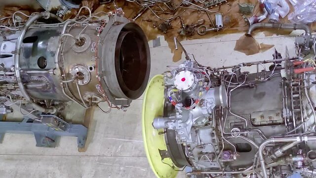 Soviet aircraft engine, standing on a pipe assembly stand. Jet engine repair. Maintenance of the turbojet engine.