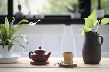 Wooden tea cup with oriental tea pot and notebook with plant pot