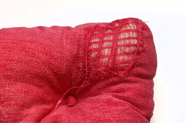 Torn up textile pillow corner