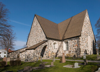 Fototapeta na wymiar Stone church from 1300s in the municipality Värmdö in Stockholm a sunny spring day. 