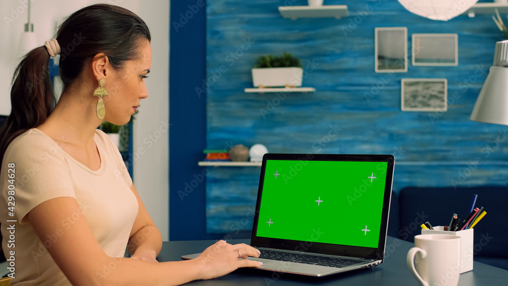 Poster freelancer working at business communication uses laptop computer with mock up green screen chroma k