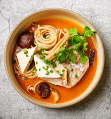 Asian fish noodle soup with tofu, greens and  shiitake mushrooms