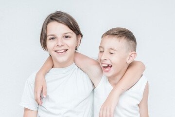 children smiling stand embracing and posing 