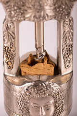 Red wine bottle, cork stopper and an italian prestigious corkscrew on a white background