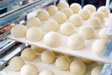 dough buns on the shelf in the bakery.
