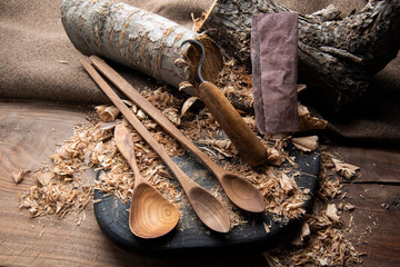 wooden spoon carver at work with hand tools