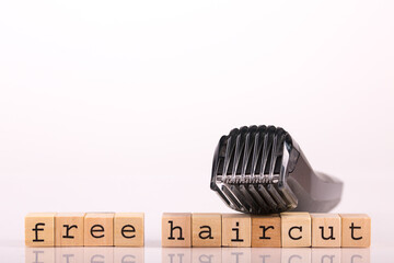 Electric shaver with lettering Free Haircut and white background: equipment for free home haircut