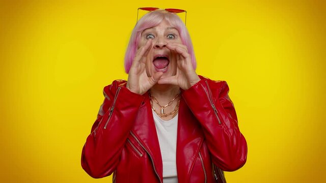 Hey you. Mature old granny rocker grandmother smiling excitedly and pointing to camera, beauty choosing lucky winner, indicating to awesome you. Senior elderly woman emo isolated on yellow background