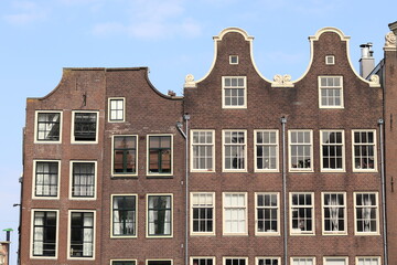Fototapeta na wymiar Amsterdam Historical House Facades with Bell Gable in the Red Light District