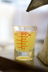 Extractor squeeze Thai lemon juice into beaker shot using  juice extractor.