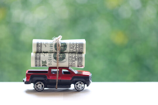 Miniature car and banknotes on nature green background, Saving money for car, Finance and car loan, Investment and business concept