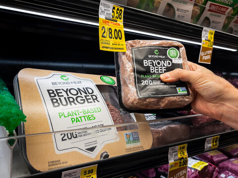 ATLANTA, GEORGIA - APRIL 24, 2021 : Customer Selecting Beyond Meat - Beyond Beef Hamburger From Grocery Store Shelf. Beyond Meat Is A Los Angeles Based Producer Of Plant-based Meat Substitutes.