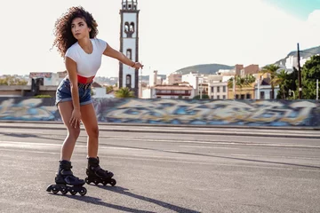Tapeten Cheerful girl on roller skates. Active and healthy lifestyle concept. © neonshot