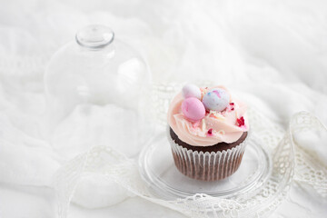Easter chocolate cupcake with caramel filling and decoration in the form of small Easter eggs from marzipan