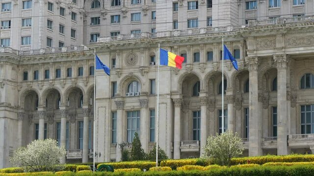 Flags Waving In Front Of Palace of the Parliament In Bucharest, Romania. medium shot