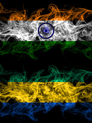 India, Indian vs Gabon, Gabonese, Gabonian smoky mystic flags placed side by side. Thick colored...