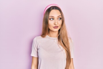 Obraz premium Young blonde girl wearing casual clothes smiling looking to the side and staring away thinking.