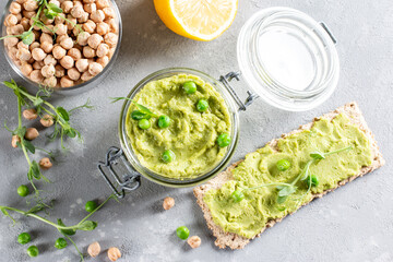 Hummus. Green pea hummus with chickpeas and green peas, olive oil. Middle east food, vegetarian snack. Top view. Copy space